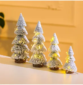 Detailed set of four mini flocked cedar Christmas trees with warm LED lights decoration.
