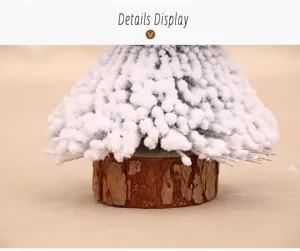 Close-up detail of a mini flocked Christmas cedar tree with a natural wooden base