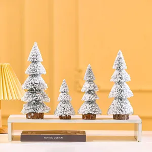 Set of four mini white flocked cedar Christmas trees for festive tabletop home decor.