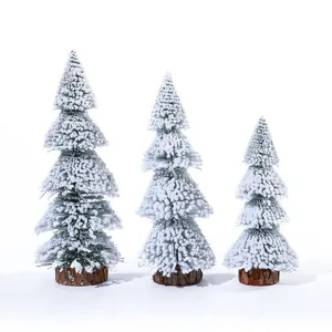 Set of three mini flocked cedar Christmas trees with wooden bases for desktop decor
