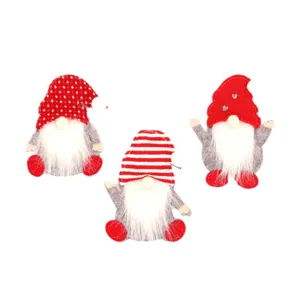 Set of three festive Christmas gnome cutlery holders with red polka dot and striped hats