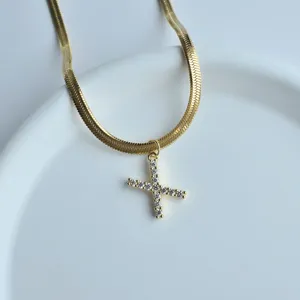 Detailed view of gold herringbone chain necklace featuring a sparkling zirconia pendant.