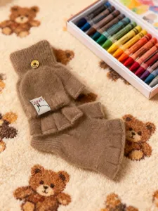 Close-up detail of cute brown fleece winter flip-top fingerless gloves with button accent.