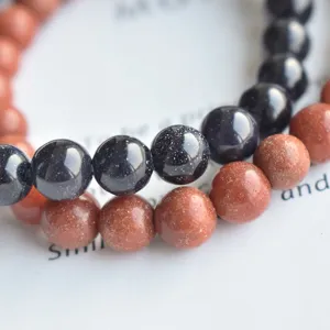 Close up detail of natural stone beaded bracelets showcasing smooth round beads and sparkly texture.