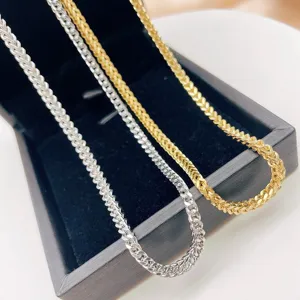 Close-up detail view of stylish stainless steel hip-hop Franco curb chains in gold and silver.