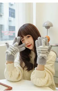 Furry winter warm touch screen gloves close up view, grey white striped knit details.