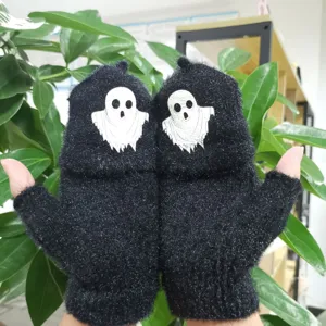 Detailed close-up view of black fuzzy half-finger convertible gloves with white ghost pattern.