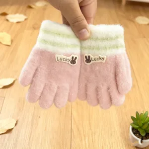 Detailed view of kids winter knitted gloves, cute pink fuzzy five-finger thermal.