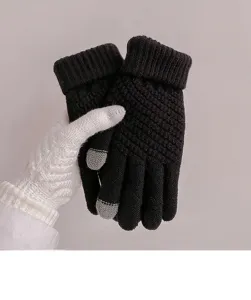 Detailed view of women's thick winter knitted touchscreen gloves with grey fingertips.