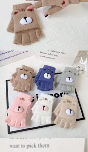 Close-up of cute winter half-finger knit gloves with plush 3D bear design and button flip.