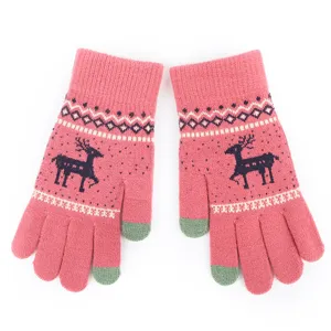 Close-up detail of winter knitted touchscreen gloves with cute deer pattern and warm fleece lining.