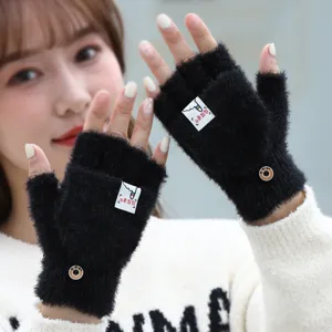 Black fuzzy convertible half finger winter gloves for women, warm knit flip top mittens.
