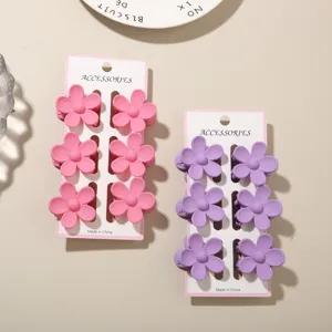 Six-piece sets of small flower hair clips in vibrant pink and purple pastel dopamine colors.