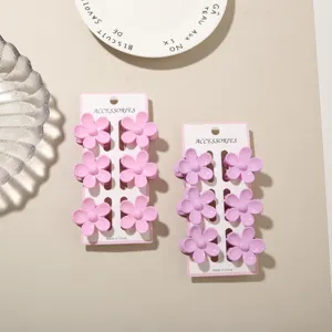 Detailed view of 6-piece matte flower hair claw clips set in dopamine pink and lavender