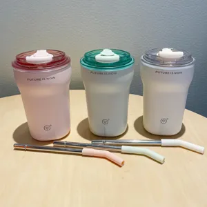 Detailed view of three pastel insulated coffee tumblers with metal straws and tips.