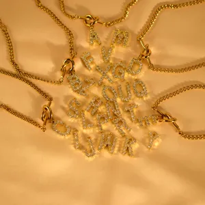 Detailed shot of 26 alphabet rhinestone letter pendants with gold chains for fashionable jewelry style.