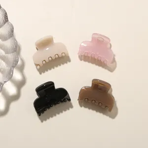 Detailed top view of four jelly-colored medium PC hair claw clips in varied pastel tones