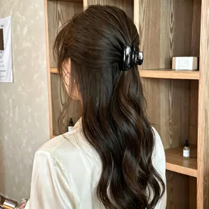 Glossy black medium hair claw clip for an elegant princess half-up hairstyle detail
