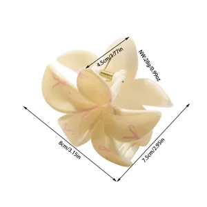 Detalle que muestra dimensiones y peso de la pinza para el pelo beige con lazos.