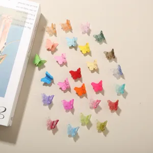 Top view of a set of colorful 2cm butterfly mini hair clips for creative hair styling