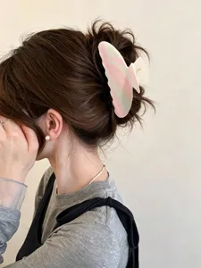 Vue détaillée d'une pince à cheveux colorée en ABS avec imprimé Happy day sur cheveux