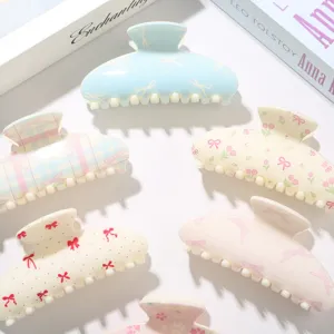 Vue détaillée de pinces à cheveux ABS 10,5 cm avec divers motifs mignons de nœuds et fleurs
