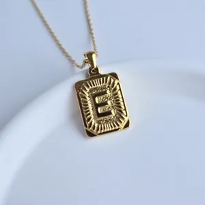 Close-up detail of the stylish gold stainless steel square letter E pendant necklace.