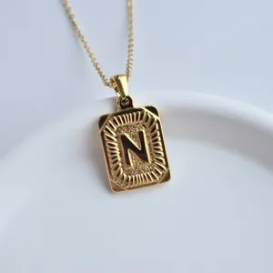 Gold stainless steel letter N square pendant necklace detail view, fashion hip-hop jewelry style.