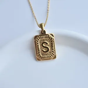 Gold square letter S pendant necklace, stainless steel jewelry detail view for daily wear.