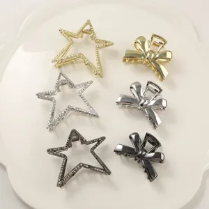 Detailed view of metallic star and bow hair claw clips in various colors on white plate