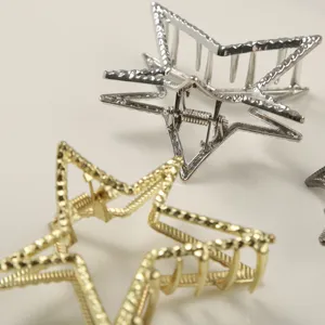 Detailed close-up view of gold and silver metallic star-shaped hair claw clips for women