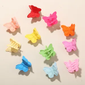 Detailed view of colorful 2cm butterfly hair claw clips in a vibrant circle arrangement.