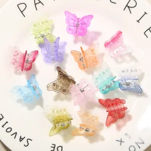 Set of colorful 2cm mini butterfly plastic hair claws on a white ceramic plate
