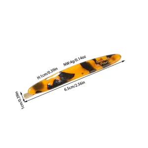 Detailed macro view of acetate tortoise shell hair clip showing precise dimensions and weight