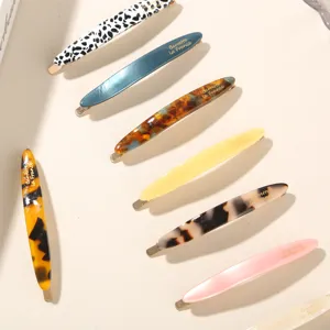 Collection of elegant acetate hair clips in tortoiseshell and solid pastel colors.