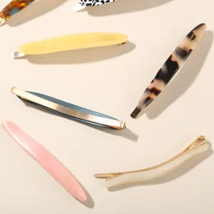 Detail shot of assorted elegant acetate hair clips featuring various colors and textures