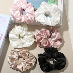 Detail showing six colors of 10cm silk-like satin hair scrunchies with soft texture.