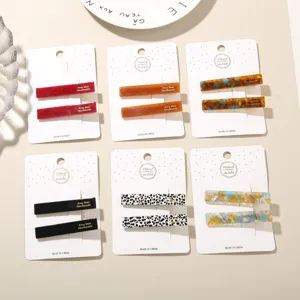 Detailed macro view showing six sets of elegant acetate duckbill hair clips in various patterns