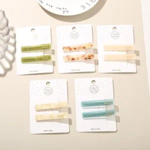 Detailed view of handmade acetate hair clip sets in various marbled and solid colors