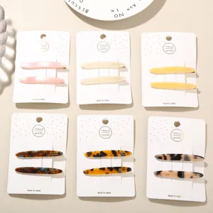 Detailed view of various acetate hair clip sets featuring tortoise and solid colors.