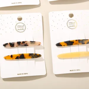 Close-up of elegant tortoise shell acetate hair clips on handmade display cards