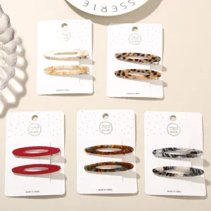 Close-up of acetate hair clip sets in leopard, marble, and solid colors.