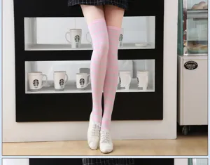 Detailed view of pink and white striped over-the-knee socks for women, stylish and cozy.