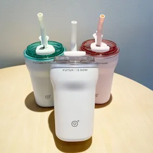 Close-up of three minimalist insulated stainless steel coffee cups with straws in pastel colors