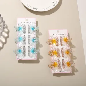 Two sets of 6 mini transparent glitter flower hair claw clips in blue and orange.