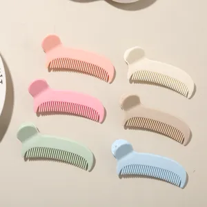 Colorful comb-shaped hair clips in pastel pink, blue, and green for styling