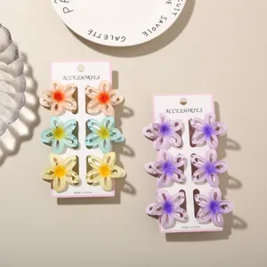 Gedetailleerd overzicht van set holle frangipani bloem haarklemmen in verloopkleuren