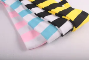 Close-up detail of colorful wide striped over-the-knee thigh high socks for women.