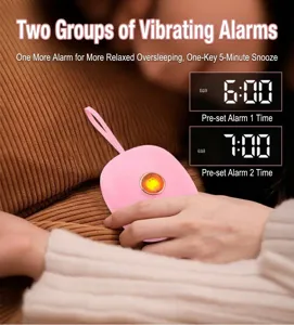 Portable pink vibrating alarm clock with dual alarm settings and convenient hanging strap for daily use.