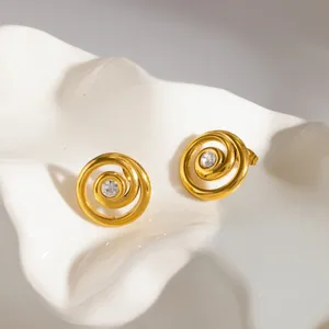 Gold spiral rhinestone stud earrings detail close up stainless steel fashion jewelry